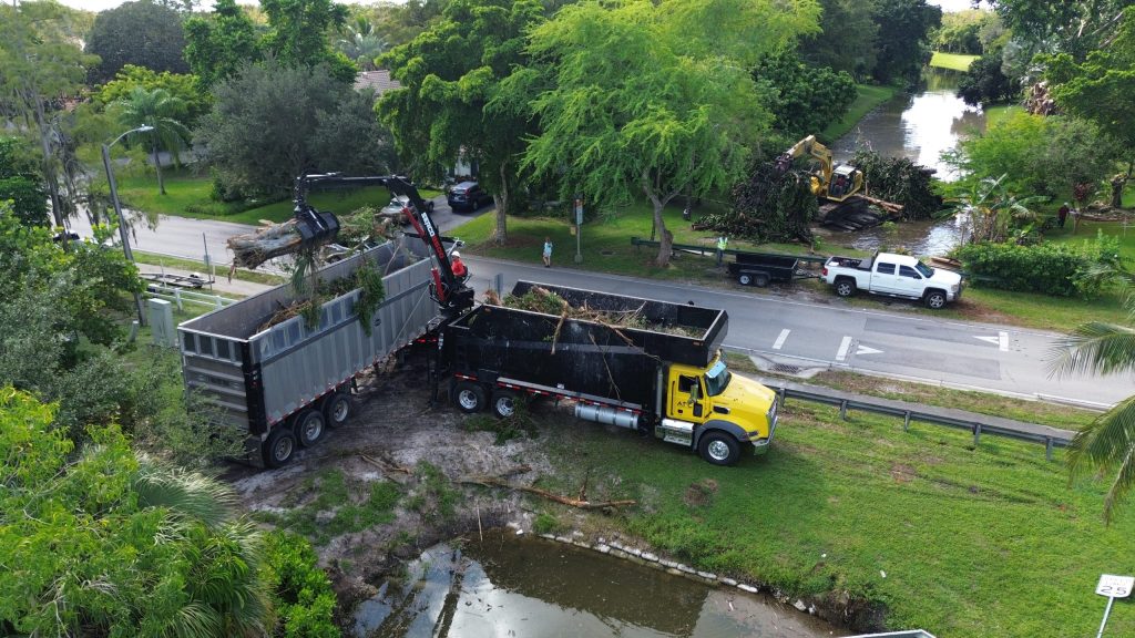 Trucks loading debris for transporting away